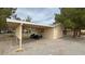 Garage and carport showcasing a practical space for vehicles and storage with lawn equipment at 3580 Unicorn Ave, Pahrump, NV 89048