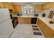 Traditional kitchen features wooden cabinets, white appliances and tile countertops at 3580 Unicorn Ave, Pahrump, NV 89048