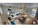 Staged living room with a fireplace, neutral colors, ceiling fans, and is adjacent to the dining area at 3580 Unicorn Ave, Pahrump, NV 89048