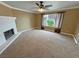 Spacious living room featuring a white brick fireplace and large window, perfect for relaxing and entertaining at 3580 Unicorn Ave, Pahrump, NV 89048