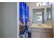 Bright bathroom with a vanity sink, wall mirror and a lighthouse-themed shower curtain at 3934 Sir Payne Ct, Las Vegas, NV 89104