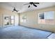 Bright living room with updated carpet, ceiling fans and natural light from windows at 3934 Sir Payne Ct, Las Vegas, NV 89104