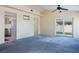 Spacious living room featuring new carpet and sliding door access to outdoor space at 3934 Sir Payne Ct, Las Vegas, NV 89104