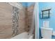 Modern bathroom featuring tiled shower and ample natural light from the window at 5010 Mick Pl, Las Vegas, NV 89103