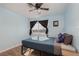Comfortable bedroom with a city view, ceiling fan, and neutral carpet at 5010 Mick Pl, Las Vegas, NV 89103
