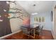 Bright dining room featuring a modern light fixture, hardwood floors, and tree mural at 5010 Mick Pl, Las Vegas, NV 89103