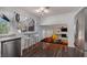 Bright kitchen with white cabinets and granite countertops, open to the living area at 5010 Mick Pl, Las Vegas, NV 89103