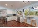 Kitchen with breakfast bar, granite countertops, stainless steel appliances, and hardwood floors at 5010 Mick Pl, Las Vegas, NV 89103