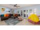 Inviting living room with a sectional sofa, colorful pillows, and easy access to the kitchen and outdoor area at 5010 Mick Pl, Las Vegas, NV 89103