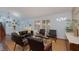 Open living room with hardwood floors, bright windows, and comfortable seating arrangements at 5010 Mick Pl, Las Vegas, NV 89103