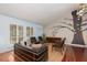 Cozy living room with a statement tree mural, hardwood floors, and natural light at 5010 Mick Pl, Las Vegas, NV 89103