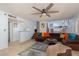 Cozy living room with a large sectional sofa, ceiling fan, and access to the kitchen and other rooms at 5010 Mick Pl, Las Vegas, NV 89103