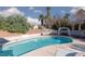 Backyard swimming pool with lounge area and landscaped perimeter in a private setting at 5010 Mick Pl, Las Vegas, NV 89103