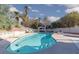 Sparkling pool with lounge chairs, mature trees, and white gazebo create a serene backyard oasis at 5010 Mick Pl, Las Vegas, NV 89103