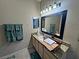 Bathroom with a large mirror, neutral walls, granite countertops, and well-lit vanity at 5250 S Rainbow Blvd # 1131, Las Vegas, NV 89118