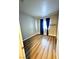 Cozy bedroom showcasing wood-look floors and a bright window with curtains at 5250 S Rainbow Blvd # 1131, Las Vegas, NV 89118