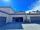 Exterior view of a townhome showcasing the architecture and a peek into an open garage at 5250 S Rainbow Blvd # 1131, Las Vegas, NV 89118