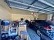 Garage interior view showing the garage door, a parked car, and assorted boxes and items at 5250 S Rainbow Blvd # 1131, Las Vegas, NV 89118