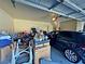 Cluttered garage interior view showing the garage door, a parked car, and assorted boxes and items at 5250 S Rainbow Blvd # 1131, Las Vegas, NV 89118