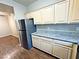 Open-concept kitchen featuring stainless steel refrigerator, granite countertops, and natural wood cabinetry at 5250 S Rainbow Blvd # 1131, Las Vegas, NV 89118