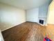 An open living room design with laminate flooring and a corner fireplace at 5250 S Rainbow Blvd # 1131, Las Vegas, NV 89118