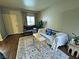 Bright living room featuring a comfortable sofa, area rug, plants, and natural light at 5250 S Rainbow Blvd # 1131, Las Vegas, NV 89118