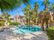 Resort-style pool area with lounge chairs, tiki umbrellas, and lush landscaping, perfect for relaxation at 5250 S Rainbow Blvd # 1131, Las Vegas, NV 89118