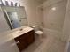 Bathroom features a single sink vanity, tile floors, and tub with tile surround at 5253 Westwind Rd, Las Vegas, NV 89118