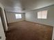 Spacious bedroom with carpet flooring features two windows and mirrored closet doors at 5253 Westwind Rd, Las Vegas, NV 89118