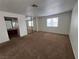 Bedroom features carpet flooring, natural light, and mirrored closet doors at 5253 Westwind Rd, Las Vegas, NV 89118