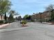 View of the community entrance gate with lush landscaping at 5253 Westwind Rd, Las Vegas, NV 89118