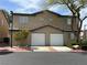 Charming townhome with stucco exterior, two-car garage, and well-kept landscaping at 5253 Westwind Rd, Las Vegas, NV 89118
