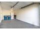 A spacious garage with a washer, dryer, blue recycling bins, and ample space at 5253 Westwind Rd, Las Vegas, NV 89118