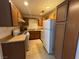 Efficient kitchen with full appliances and tiled flooring and wood cabinets at 5253 Westwind Rd, Las Vegas, NV 89118