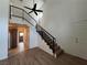 Sunlit living room features hardwood floors, high ceilings, and staircase at 5253 Westwind Rd, Las Vegas, NV 89118