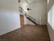Spacious living room with staircase, ceiling fan, wood flooring, and natural light at 5253 Westwind Rd, Las Vegas, NV 89118