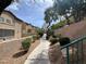 Exterior image of a community walking path with landscaping and block walls at 5253 Westwind Rd, Las Vegas, NV 89118