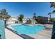 Community pool with ample seating and a cabana, perfect for relaxing and enjoying the outdoors at 5253 Westwind Rd, Las Vegas, NV 89118