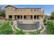 Backyard featuring a patio, seating, lush landscaping, and a view of the beautiful two-story house at 549 Via Balizan Ave, Las Vegas, NV 89123