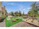 Spacious backyard featuring modern landscaping, artificial grass, trees, and gravel areas at 549 Via Balizan Ave, Las Vegas, NV 89123