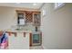 Cozy bar area featuring wooden cabinets, granite countertops, wine rack, and a beverage cooler at 549 Via Balizan Ave, Las Vegas, NV 89123
