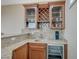 This bar features wooden cabinets, granite countertops, sink, beverage cooler, and wine storage at 549 Via Balizan Ave, Las Vegas, NV 89123
