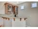 This cozy bar area features wooden cabinets, granite countertops, and additional counter seating at 549 Via Balizan Ave, Las Vegas, NV 89123