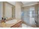 Bathroom features granite countertop, glass shower, and tile flooring at 549 Via Balizan Ave, Las Vegas, NV 89123