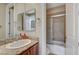 Bright bathroom featuring double sinks with granite countertops and a shower-tub combo behind a sliding door at 549 Via Balizan Ave, Las Vegas, NV 89123