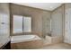 Stylish bathroom featuring a bathtub, shower and earth-toned tile throughout at 549 Via Balizan Ave, Las Vegas, NV 89123