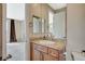 Bathroom featuring granite countertop, wood cabinets, decorative mirrors, and tile flooring at 549 Via Balizan Ave, Las Vegas, NV 89123