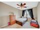Well-lit bedroom with ceiling fan, complemented by a full-sized bed and secondary bed at 549 Via Balizan Ave, Las Vegas, NV 89123
