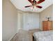 Well-lit bedroom with ceiling fan, complemented by a full-sized bed and closet at 549 Via Balizan Ave, Las Vegas, NV 89123