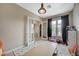 Bedroom with dual french doors, a table and chairs, and dark curtains at 549 Via Balizan Ave, Las Vegas, NV 89123
